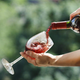 pouring red wine into glass